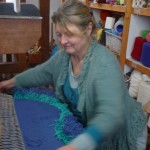 Jill making a knotted pile rug on a weaving course